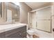 A stylish bathroom featuring a gray vanity with a modern sink and a shower-tub combo at 5733 Dazzling Sparks St, North Las Vegas, NV 89031