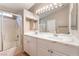Bright bathroom featuring double sinks with marble countertops, a shower, and a tub at 5733 Dazzling Sparks St, North Las Vegas, NV 89031
