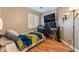 Comfortable bedroom with a sleek desk setup, modern lighting, and wood laminate flooring at 5733 Dazzling Sparks St, North Las Vegas, NV 89031