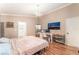 Spacious bedroom featuring a desk area, stylish chandelier, and an adjoining bathroom at 5733 Dazzling Sparks St, North Las Vegas, NV 89031