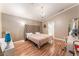 Bedroom with a large bed, hardwood floors, and a view into the en suite bathroom at 5733 Dazzling Sparks St, North Las Vegas, NV 89031