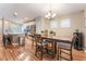 Dining area with modern chandelier, leading into an island kitchen, and stainless steel appliances at 5733 Dazzling Sparks St, North Las Vegas, NV 89031