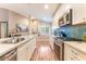 Stylish kitchen featuring white cabinets, stainless steel appliances, and a blue-tiled backsplash at 5733 Dazzling Sparks St, North Las Vegas, NV 89031