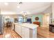 Open concept kitchen and dining area with center island, stainless appliances, and hardwood floors at 5733 Dazzling Sparks St, North Las Vegas, NV 89031