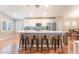 Kitchen island with barstool seating, stainless appliances, granite countertops, and wood floors at 5733 Dazzling Sparks St, North Las Vegas, NV 89031