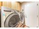 Laundry room including side-by-side, front-loading washer and dryer set at 5733 Dazzling Sparks St, North Las Vegas, NV 89031