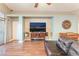 Inviting living room featuring hardwood floors, a modern entertainment center, and cozy decor at 5733 Dazzling Sparks St, North Las Vegas, NV 89031