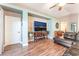 Comfortable living room with a large TV, hardwood floors and neutral color scheme at 5733 Dazzling Sparks St, North Las Vegas, NV 89031