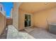 An empty covered patio area with concrete foundation and sliding glass door access to the home at 6048 Aripeka St, Henderson, NV 89011