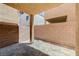 An empty covered patio area with concrete foundation and cinderblock walls, ready for personalization at 6048 Aripeka St, Henderson, NV 89011