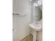 Powder room featuring a pedestal sink, modern fixtures, and a neutral color palette at 6048 Aripeka St, Henderson, NV 89011