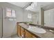 Bathroom featuring double sinks, granite counters, and vanity lighting at 6048 Aripeka St, Henderson, NV 89011