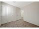 Bright bedroom featuring neutral walls, plush carpeting, and a spacious closet with classic white doors at 6048 Aripeka St, Henderson, NV 89011