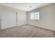 Bedroom with carpet flooring, sliding closet doors, and natural lighting at 6048 Aripeka St, Henderson, NV 89011