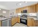 Well-lit kitchen with stainless steel appliances and a modern aesthetic at 6048 Aripeka St, Henderson, NV 89011