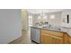 Kitchen featuring stainless steel dishwasher and access to the dining area at 6048 Aripeka St, Henderson, NV 89011