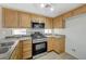 Cozy kitchen features stainless steel appliances and warm wood cabinetry at 6048 Aripeka St, Henderson, NV 89011