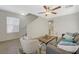 Bright living room showcasing staircase, neutral colors, wood-look tile, and comfortable seating arrangement at 6048 Aripeka St, Henderson, NV 89011