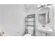 Cozy bathroom featuring a pedestal sink and shelving at 6068 Conroe Ct, Las Vegas, NV 89118