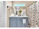 Stylish bathroom featuring a blue vanity, double sinks, and modern decorative accents at 6068 Conroe Ct, Las Vegas, NV 89118