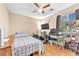 Sunlit bedroom with a ceiling fan, large window and a desk at 6068 Conroe Ct, Las Vegas, NV 89118