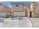Two-story home showcasing a neutral-toned facade, a two-car garage, and a well-maintained front yard at 6068 Conroe Ct, Las Vegas, NV 89118