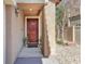 Inviting front entrance featuring a classic door, textured walls, and landscaping, enhancing curb appeal at 6068 Conroe Ct, Las Vegas, NV 89118