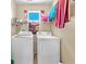Functional laundry room with washer, dryer, and shelving for storage at 6068 Conroe Ct, Las Vegas, NV 89118