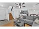 Spacious living room with a cozy sectional, staircase and convenient access to the kitchen and dining area at 6068 Conroe Ct, Las Vegas, NV 89118