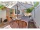 Charming patio area with outdoor seating, an umbrella, and privacy fencing at 6068 Conroe Ct, Las Vegas, NV 89118
