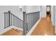 Hardwood staircase and floors lead to a hallway at 6068 Conroe Ct, Las Vegas, NV 89118