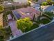 Aerial view of a luxury home with a tile roof, desert landscaping, and solar panels at 6120 Kings Brook Ct, Las Vegas, NV 89149