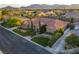Stunning aerial view of custom home featuring tile roof, lush landscaping, and mountain views at 6120 Kings Brook Ct, Las Vegas, NV 89149