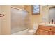 Bathroom with tiled shower and sliding glass door, wood vanity, and neutral color scheme at 6120 Kings Brook Ct, Las Vegas, NV 89149