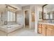 Bathroom boasts a soaking tub, glass shower, stylish fixtures, and vanity at 6120 Kings Brook Ct, Las Vegas, NV 89149