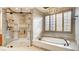 Elegant bathroom showcasing a modern glass shower, soaking tub, and stylish light fixtures and fixtures at 6120 Kings Brook Ct, Las Vegas, NV 89149