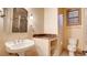 Vintage-inspired bathroom with pedestal sink, stylish tiles, and toilet area at 6120 Kings Brook Ct, Las Vegas, NV 89149