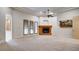 Large bedroom with carpet flooring, trey ceilings, a cozy fireplace, and bright natural light at 6120 Kings Brook Ct, Las Vegas, NV 89149