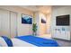 Staged bedroom with neutral carpet, closet, and attached ensuite at 6120 Kings Brook Ct, Las Vegas, NV 89149