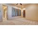 Bedroom showcasing carpet floors, and natural light from shuttered windows and an exterior door at 6120 Kings Brook Ct, Las Vegas, NV 89149