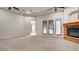 Spacious bedroom featuring a fireplace, carpeted floors, trey ceilings, and natural light from french doors at 6120 Kings Brook Ct, Las Vegas, NV 89149