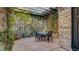 Private courtyard patio area featuring a trellis, climbing vines, and comfortable seating at 6120 Kings Brook Ct, Las Vegas, NV 89149