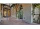 Charming courtyard featuring an iron gate, decorative windows, and climbing vines at 6120 Kings Brook Ct, Las Vegas, NV 89149