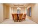 Formal dining room featuring elegant chandelier, plush seating and plantation shutters at 6120 Kings Brook Ct, Las Vegas, NV 89149