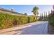 Long driveway leading to home with mature landscaping and manicured hedges at 6120 Kings Brook Ct, Las Vegas, NV 89149