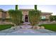 Inviting front entrance with mature landscaping, stone accents, and walkway with artificial turf at 6120 Kings Brook Ct, Las Vegas, NV 89149