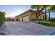 Spacious three-car garage featuring an expansive driveway with attractive design at 6120 Kings Brook Ct, Las Vegas, NV 89149
