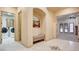 Hallway featuring niche, laundry room, and open view to bedroom with covered patio at 6120 Kings Brook Ct, Las Vegas, NV 89149