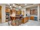 Gourmet kitchen boasts granite island with seating, stainless appliances, and custom cabinetry at 6120 Kings Brook Ct, Las Vegas, NV 89149