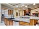 Granite countertop island in a kitchen with stainless steel appliances and wood cabinetry at 6120 Kings Brook Ct, Las Vegas, NV 89149